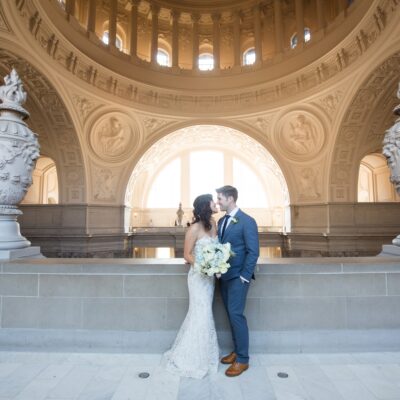 Couple portrait on the 4th floor rotunda balcony at San Francisco City Hall